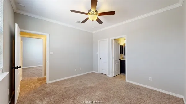 an empty room with closet and a chandelier fan