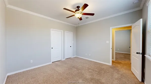 a view of a patio with table and chairs and wooden fence
