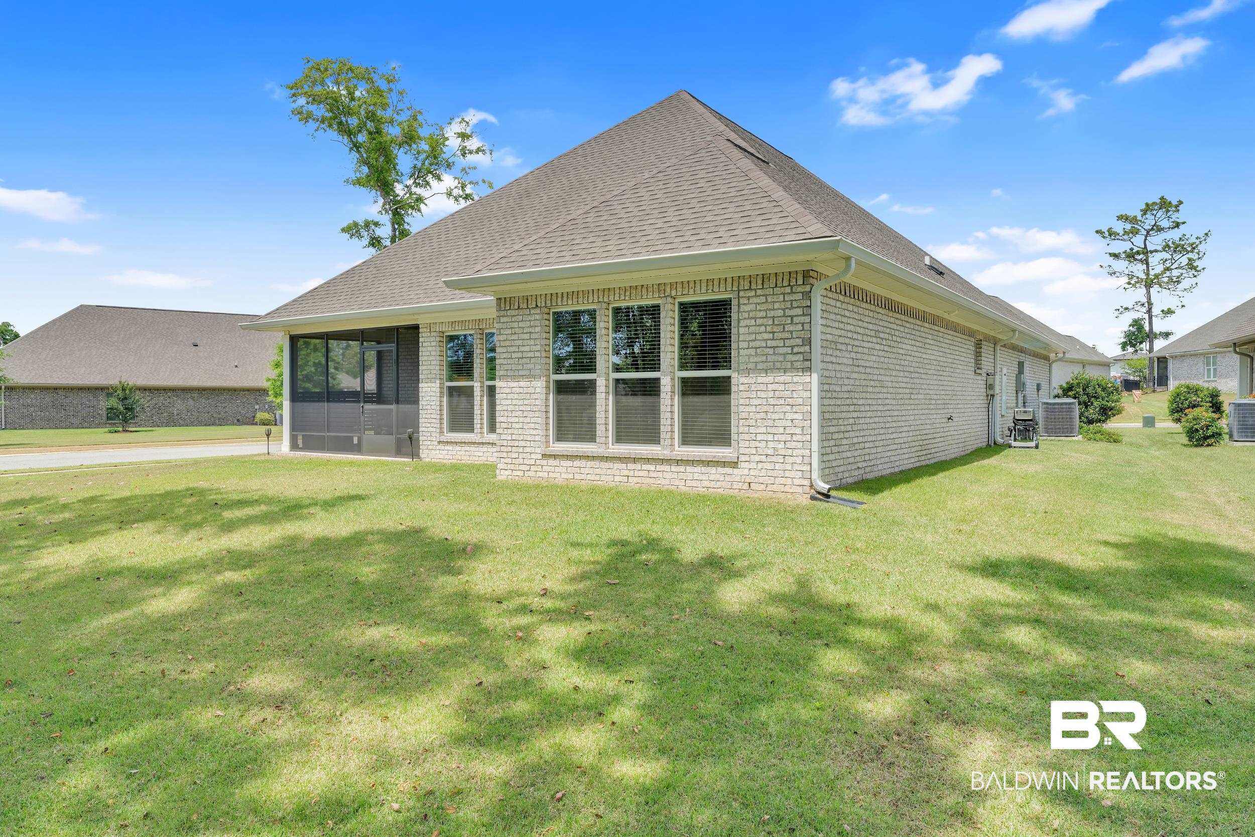 31630 Canopy Loop Daphne, AL 36527 - Photo 22 of 30 Rear view of property with cooling unit, roof with shingles, brick siding, a sunroom, and a yard