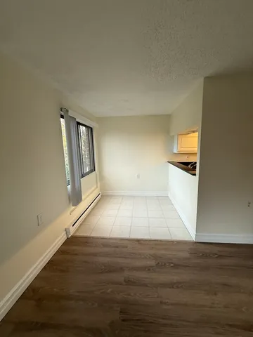 a view of a room with wooden floor and staircase
