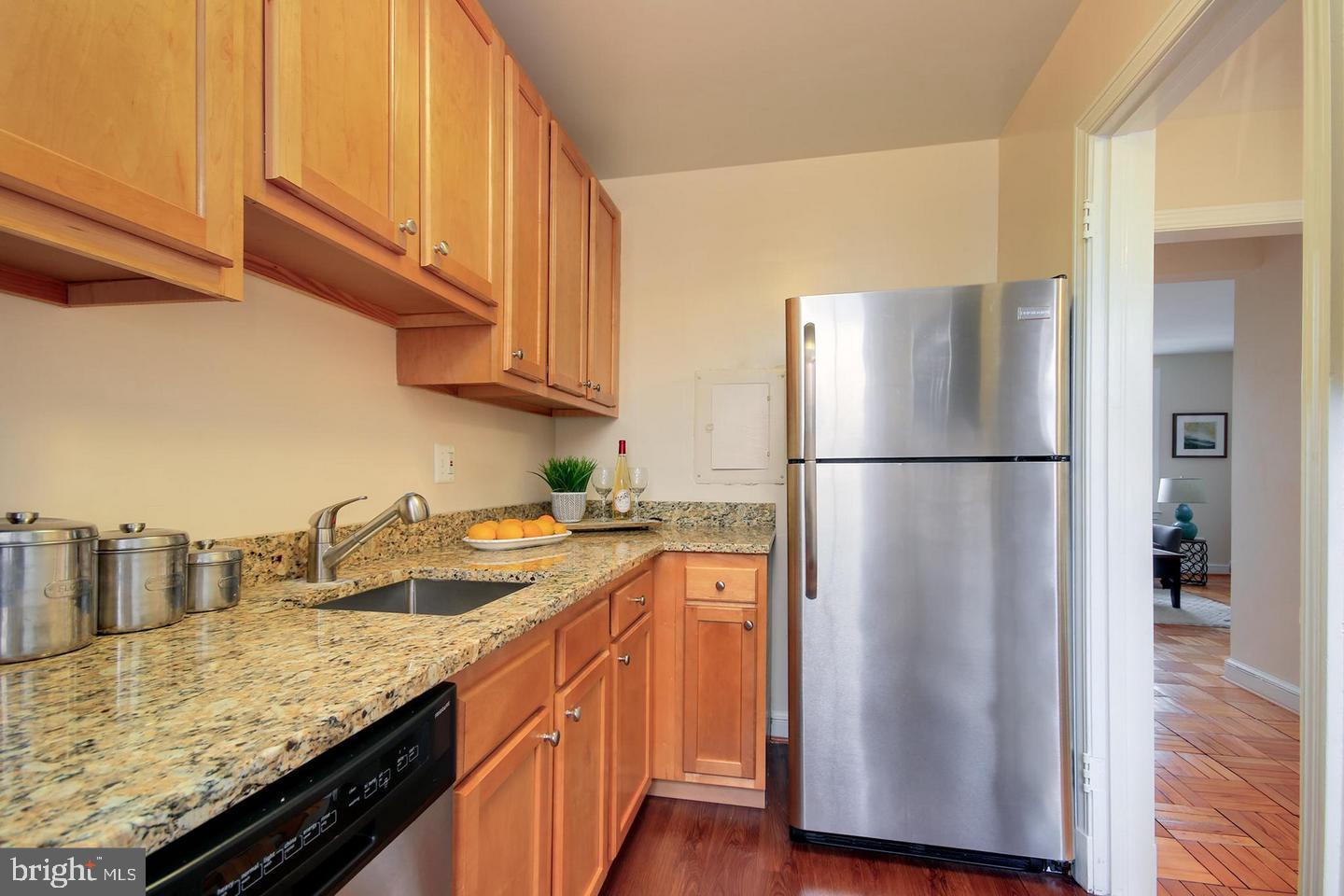 2712 Ordway Street Northwest, Unit 5 Washington, DC 20008 - Photo 14 of 26 a kitchen with stainless steel appliances granite countertop a refrigerator a sink and a stove