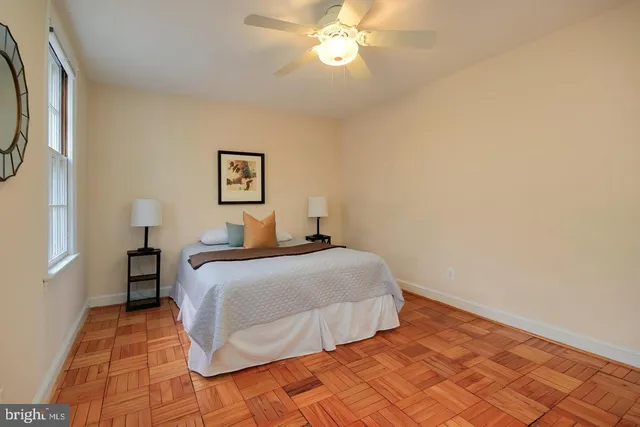 a bedroom with a large bed and a window