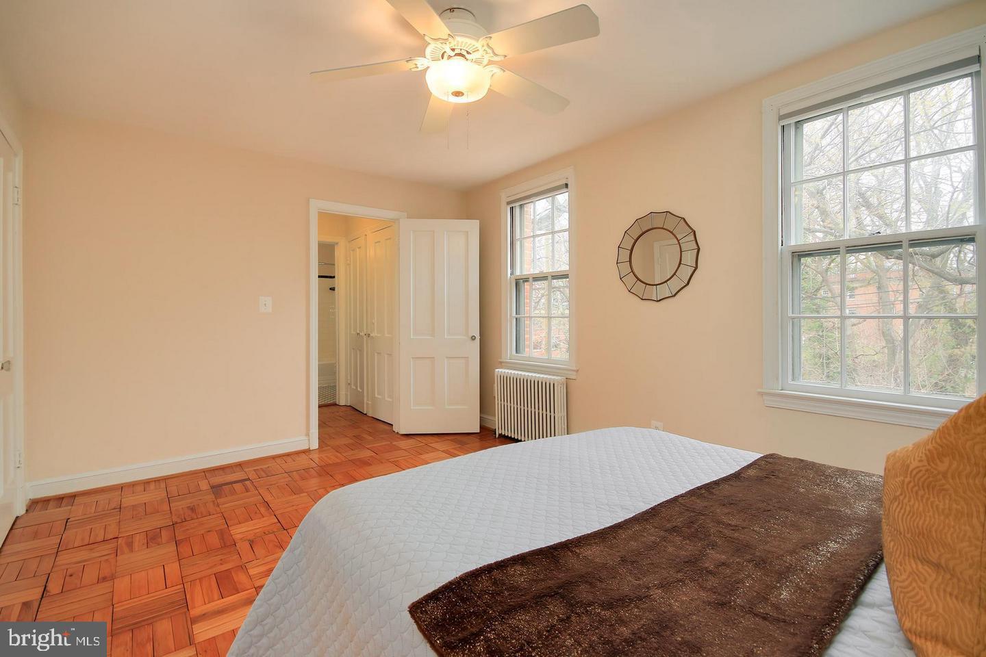 2712 Ordway Street Northwest, Unit 5 Washington, DC 20008 - Photo 20 of 26 a bedroom with a large bed and a chandelier