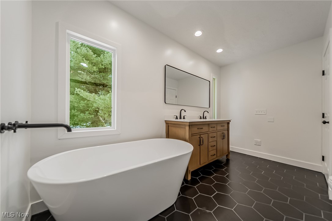7488 Greenwich Road Seville, OH 44273 - Photo 21 of 37 Bathroom featuring double vanity, a soaking tub, recessed lighting, and dark tile patterned floors