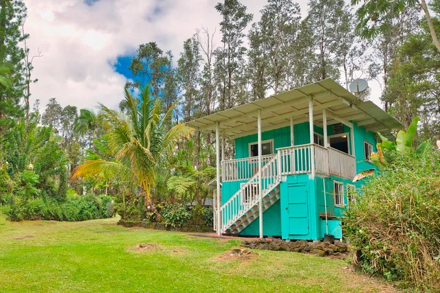 a view of a house with a yard and plants