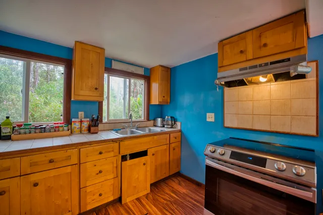 a kitchen with wooden cabinets and a stove top oven