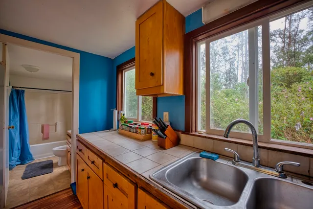 a kitchen with a sink and a large window