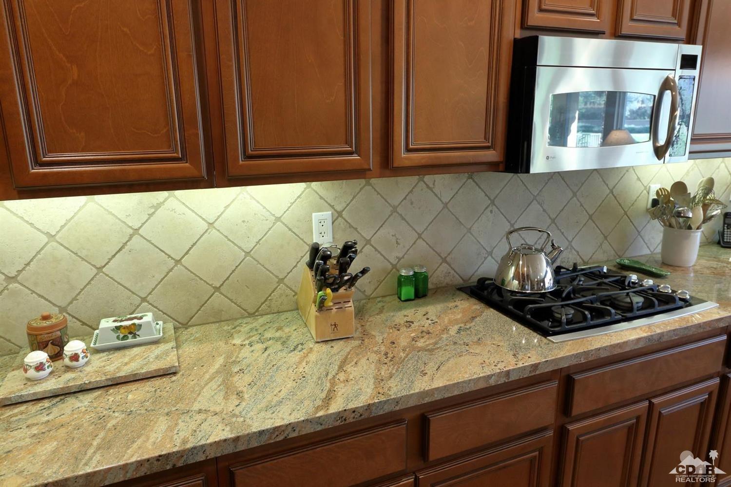 81757 Rustic Canyon Drive La Quinta, CA 92253 - Photo 14 of 40 a kitchen with a sink and cabinets