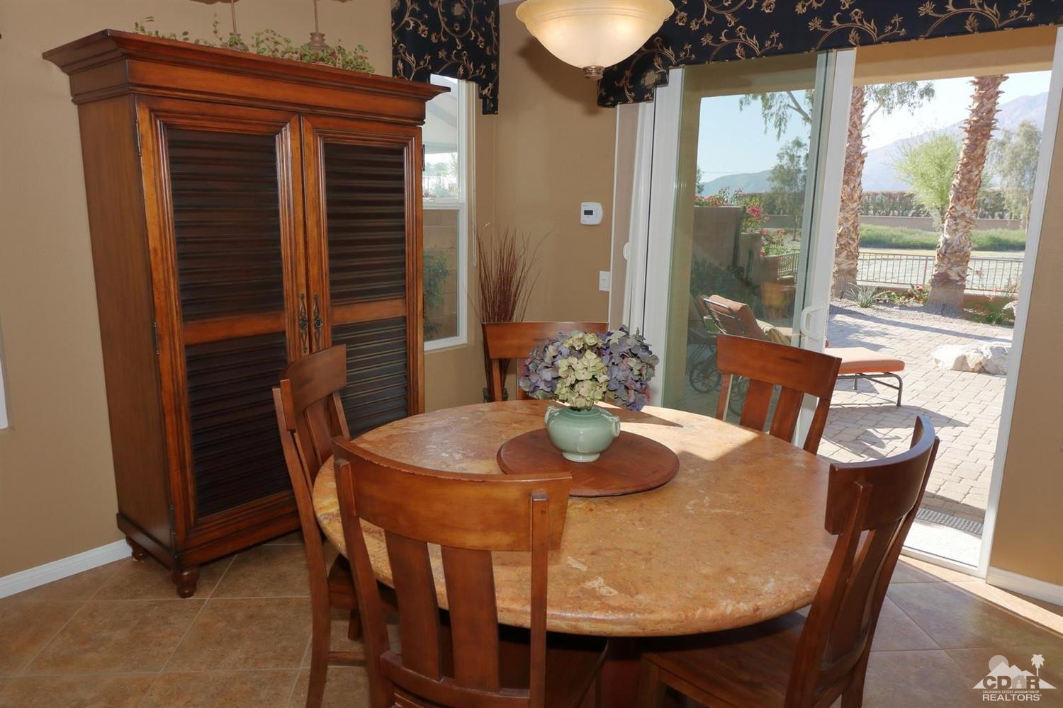 81757 Rustic Canyon Drive La Quinta, CA 92253 - Photo 17 of 40 a dining room with furniture and wooden floor