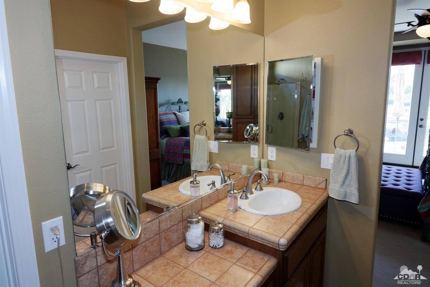 81757 Rustic Canyon Drive La Quinta, CA 92253 - Photo 23 of 40 a bathroom with a sink vanity granite and a mirror