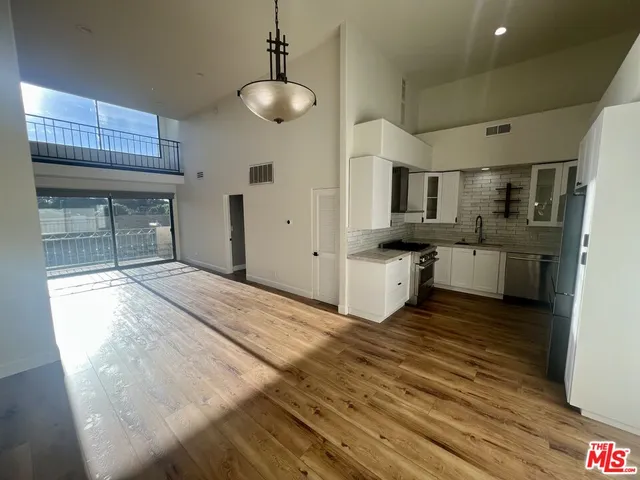 a view of a kitchen with microwave and cabinets