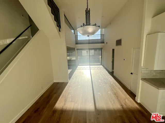 a view of a room with wooden floor and staircase