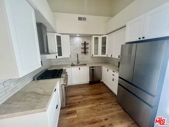 a large kitchen with a stove and refrigerator