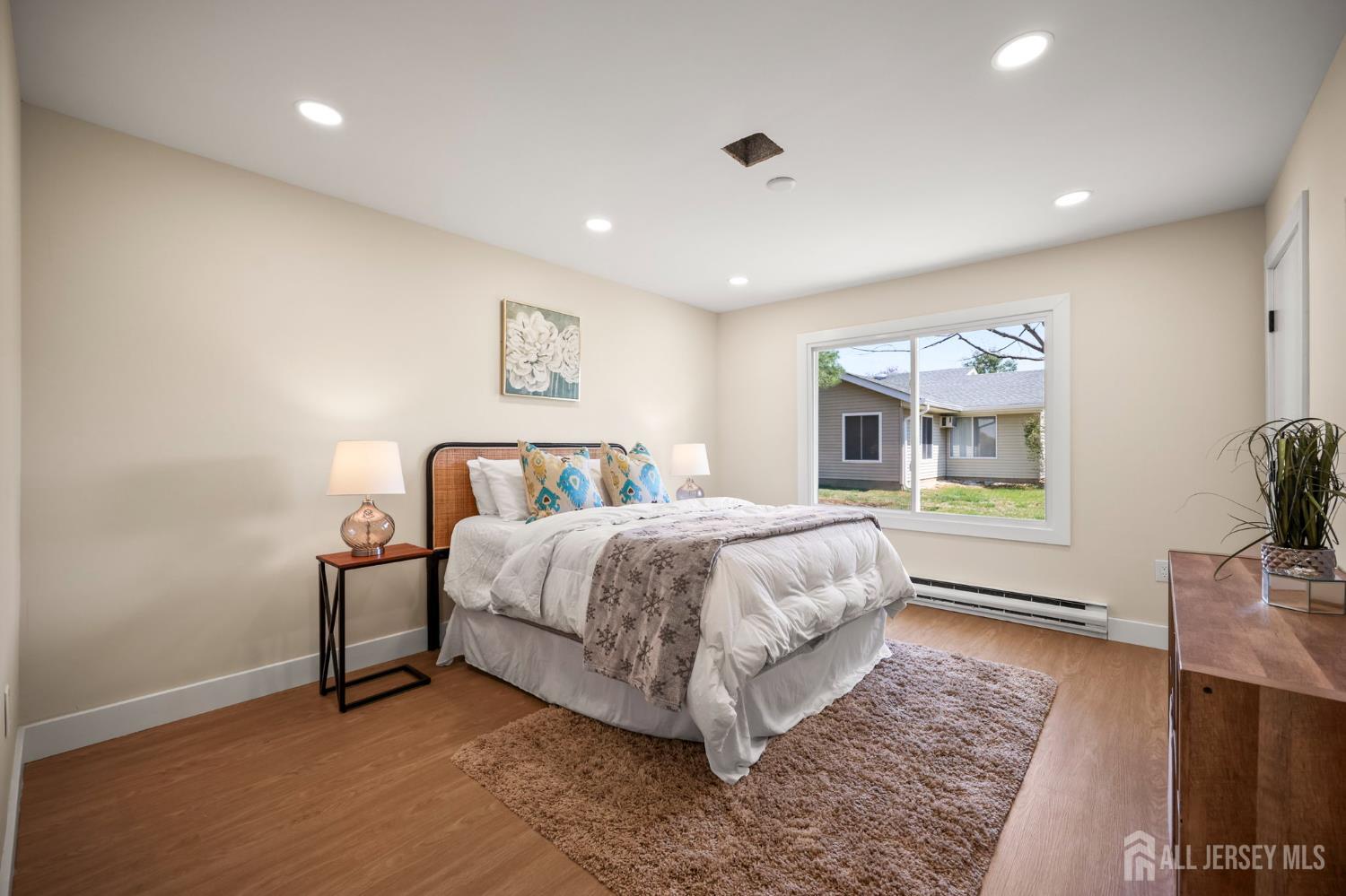 701 Croydon Road, Unit A Monroe Township, NJ 08831 - Photo 22 of 34 a spacious bedroom with a bed and a dresser next to a window