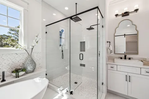 a bathroom with a sink and a mirror with bathtub