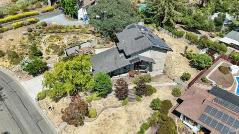 an aerial view of a house with a yard