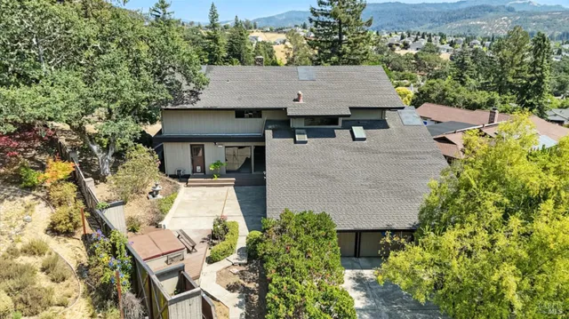 an aerial view of a house with swimming pool and garden