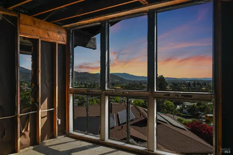 a view of a glass door with a balcony from a window