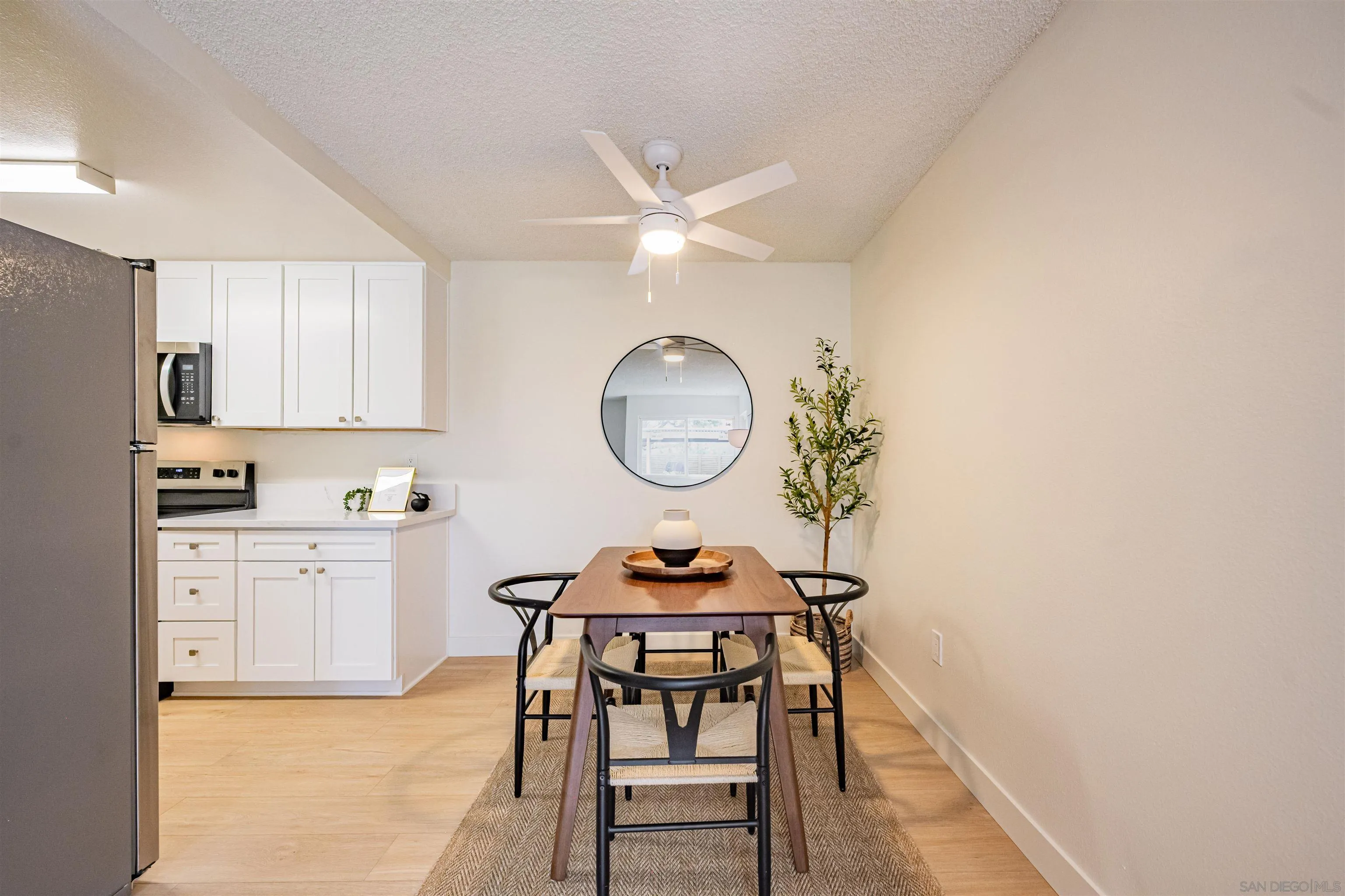 12609 Robison Boulevard, Unit 108 Poway, CA 92064 - Photo 19 of 27 a kitchen with stainless steel appliances a stove a chimney a dining table and chairs
