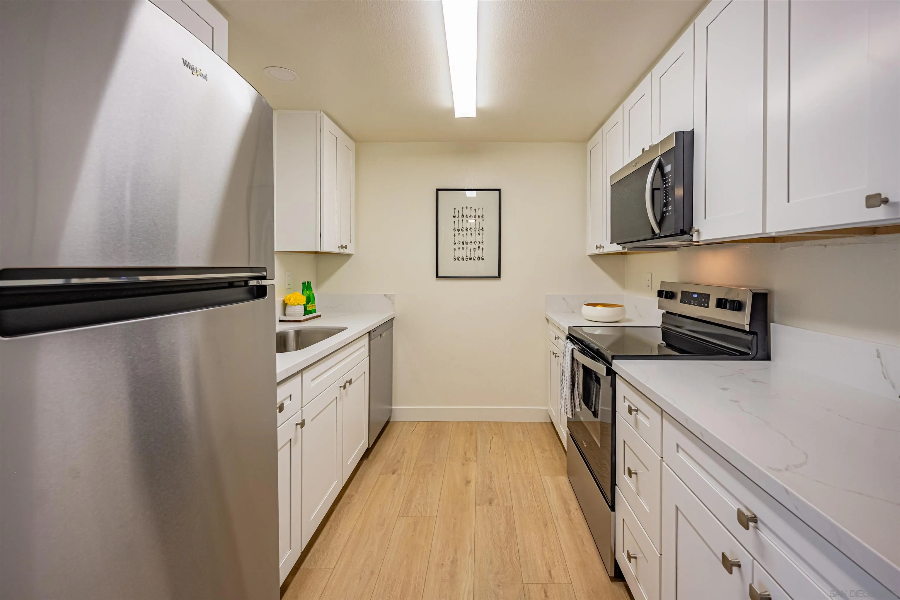 12609 Robison Boulevard, Unit 108 Poway, CA 92064 - Photo 27 of 27 a kitchen with stainless steel appliances a refrigerator a sink and white cabinets