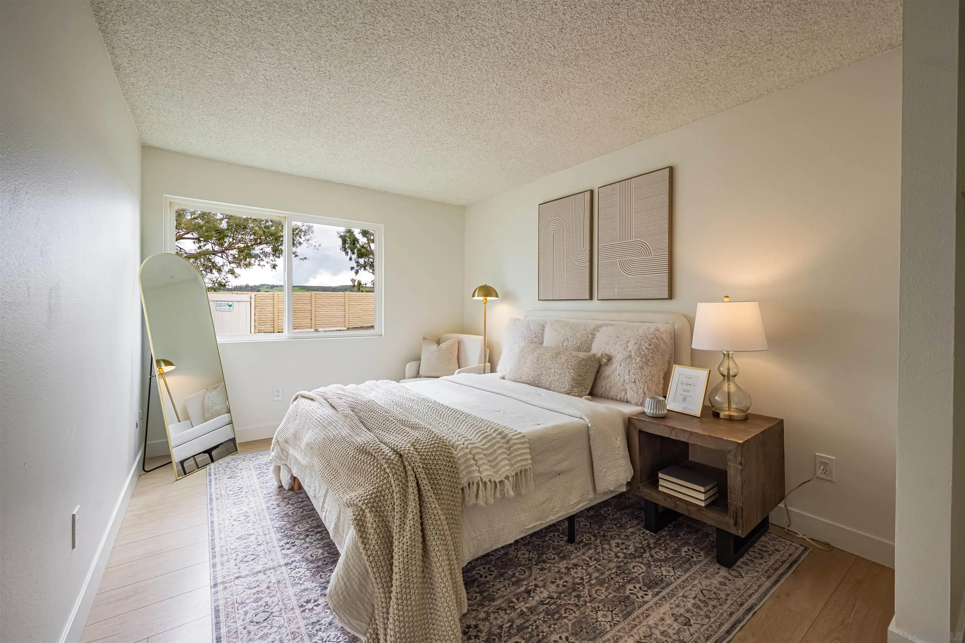 12609 Robison Boulevard, Unit 108 Poway, CA 92064 - Photo 3 of 27 a bedroom with a bed and wooden floor