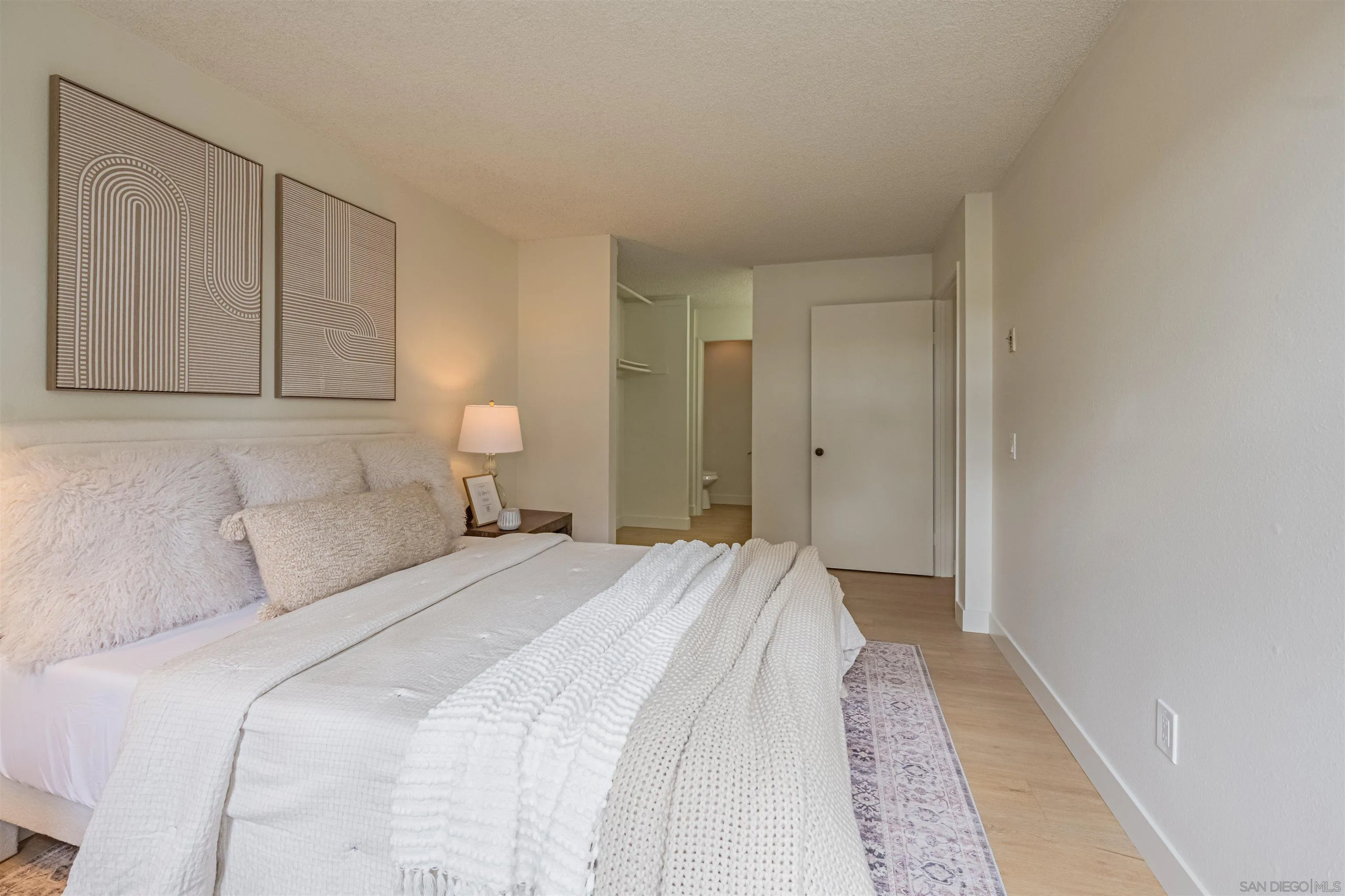 12609 Robison Boulevard, Unit 108 Poway, CA 92064 - Photo 4 of 27 a bedroom with a bed and lamp