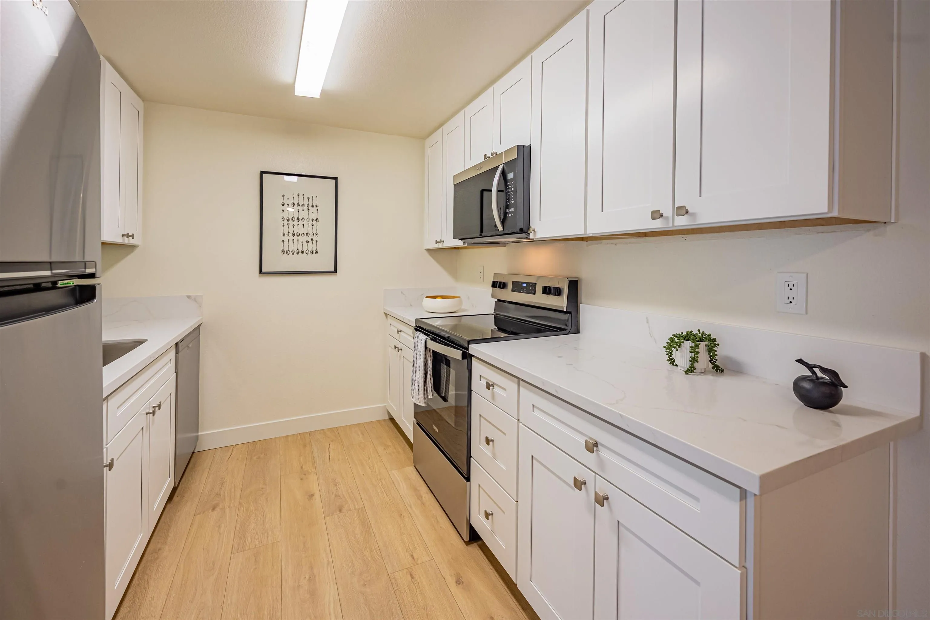 12609 Robison Boulevard, Unit 108 Poway, CA 92064 - Photo 6 of 27 a kitchen with stainless steel appliances granite countertop a sink and a stove top oven