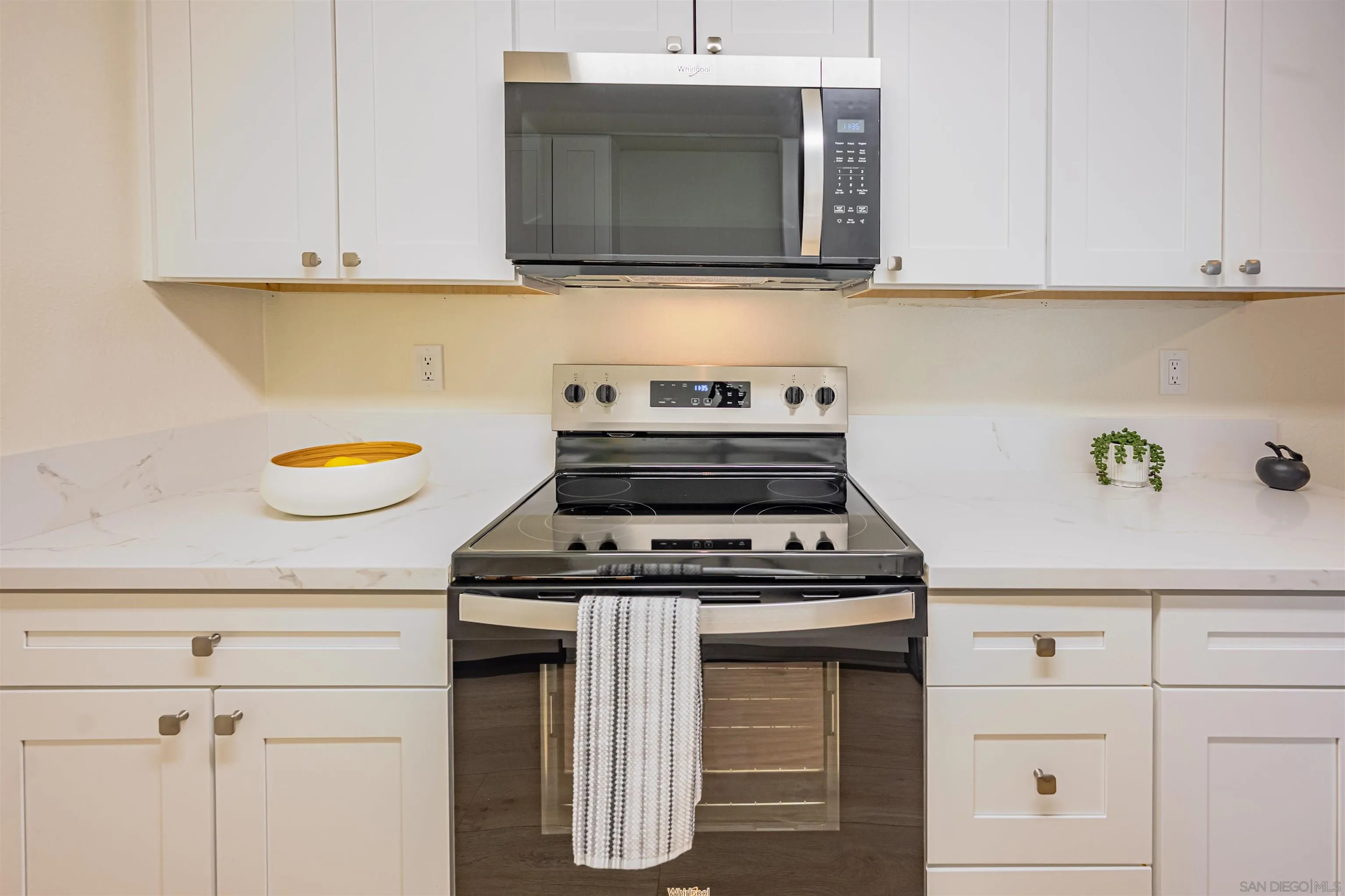 12609 Robison Boulevard, Unit 108 Poway, CA 92064 - Photo 10 of 27 a kitchen with granite countertop cabinets stainless steel appliances and wooden floor