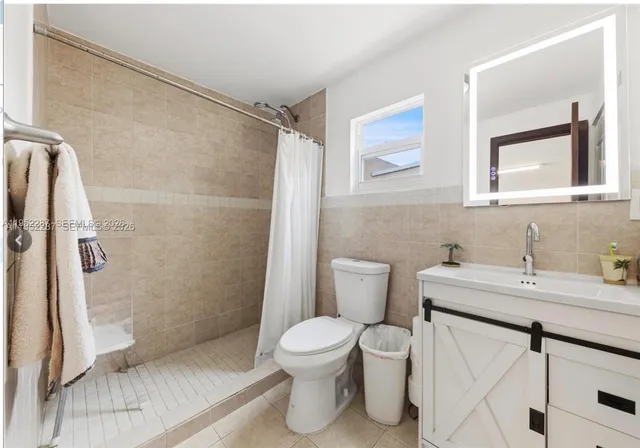 a bathroom with a toilet sink and shower
