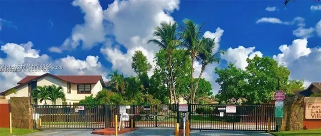 a view of a house with a tree and a yard
