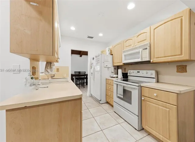 a kitchen with stainless steel appliances granite countertop a sink and a stove