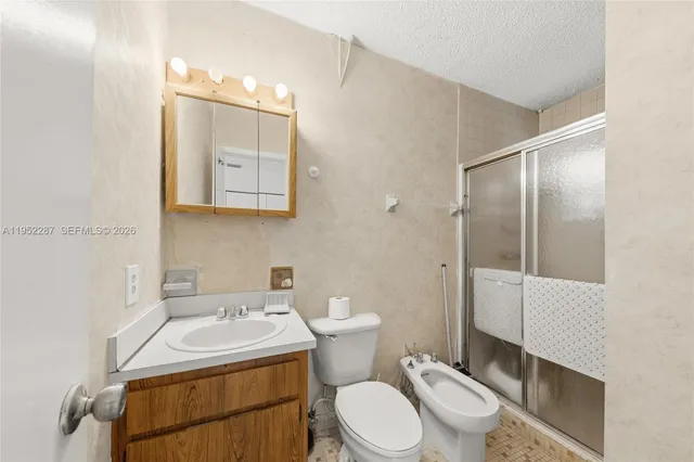 a bathroom with a sink toilet and mirror