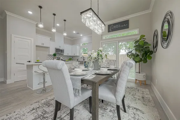 a view of a dining room with furniture and a chandelier