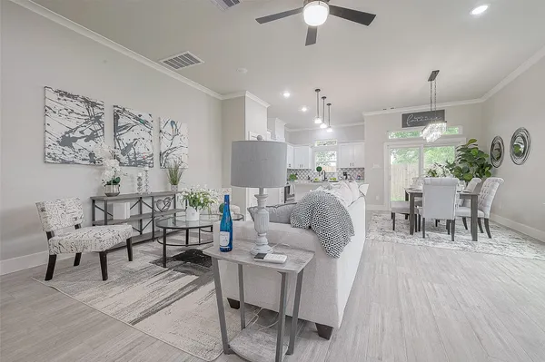 a living room with furniture and a chandelier