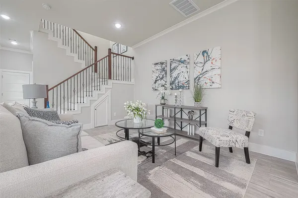 a living room with furniture and wooden floor