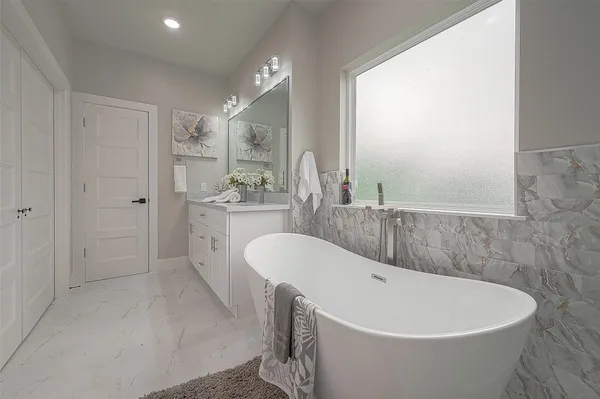 a bathroom with a bathtub and a sink