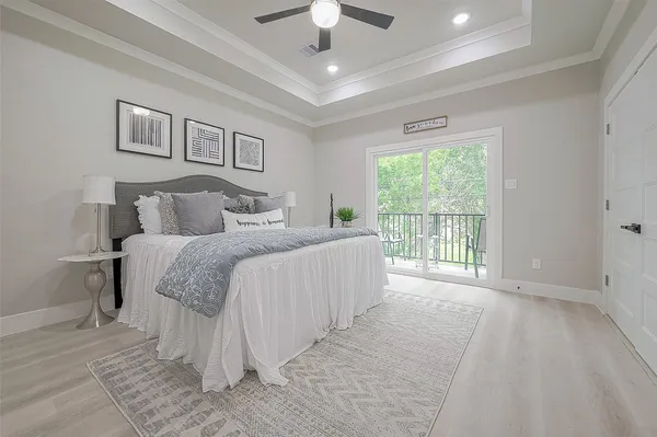 a spacious bedroom with a large bed and a chandelier