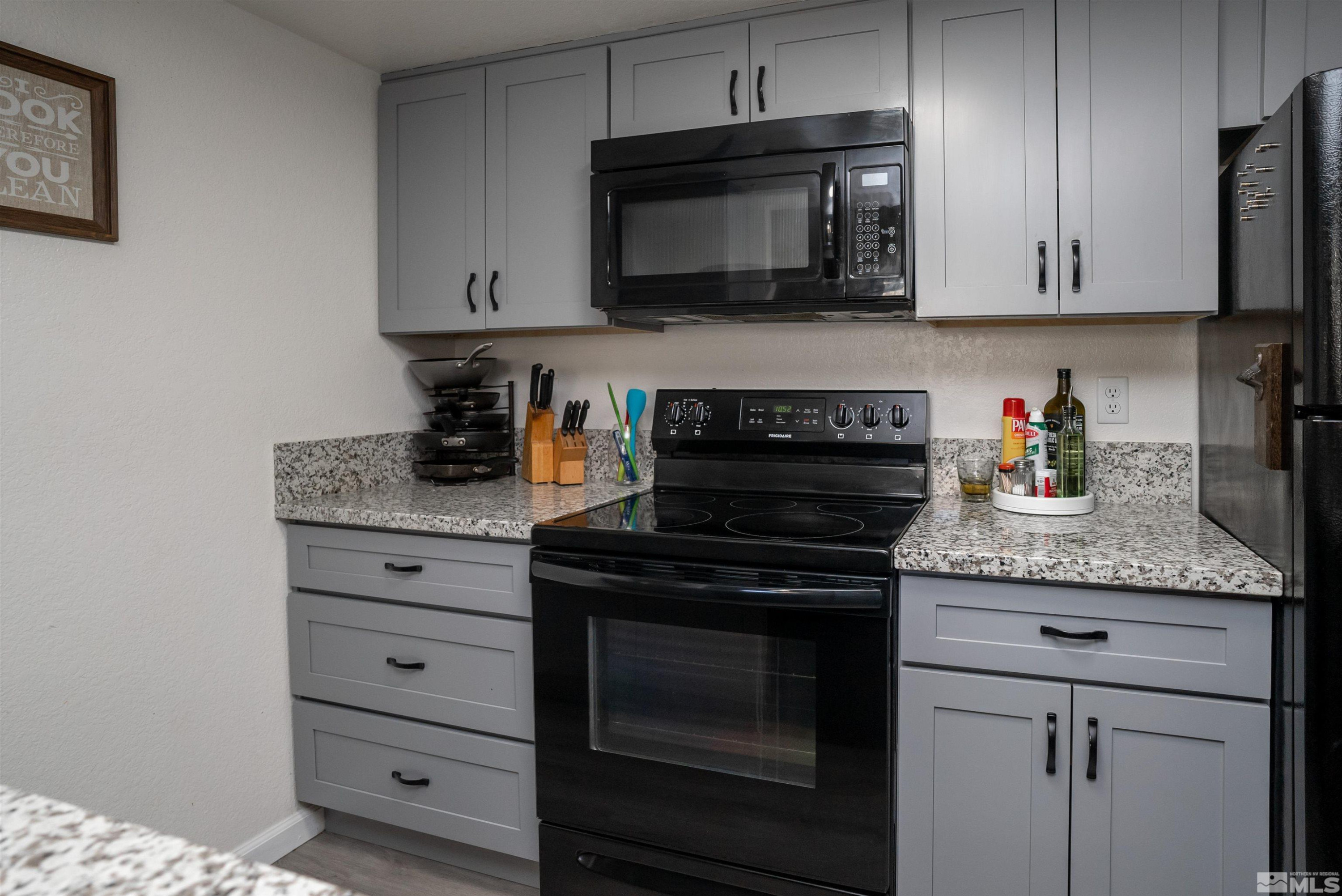 13864 Lear Boulevard Reno, NV 89506 - Photo 11 of 31 a kitchen with granite countertop white cabinets and stainless steel appliances