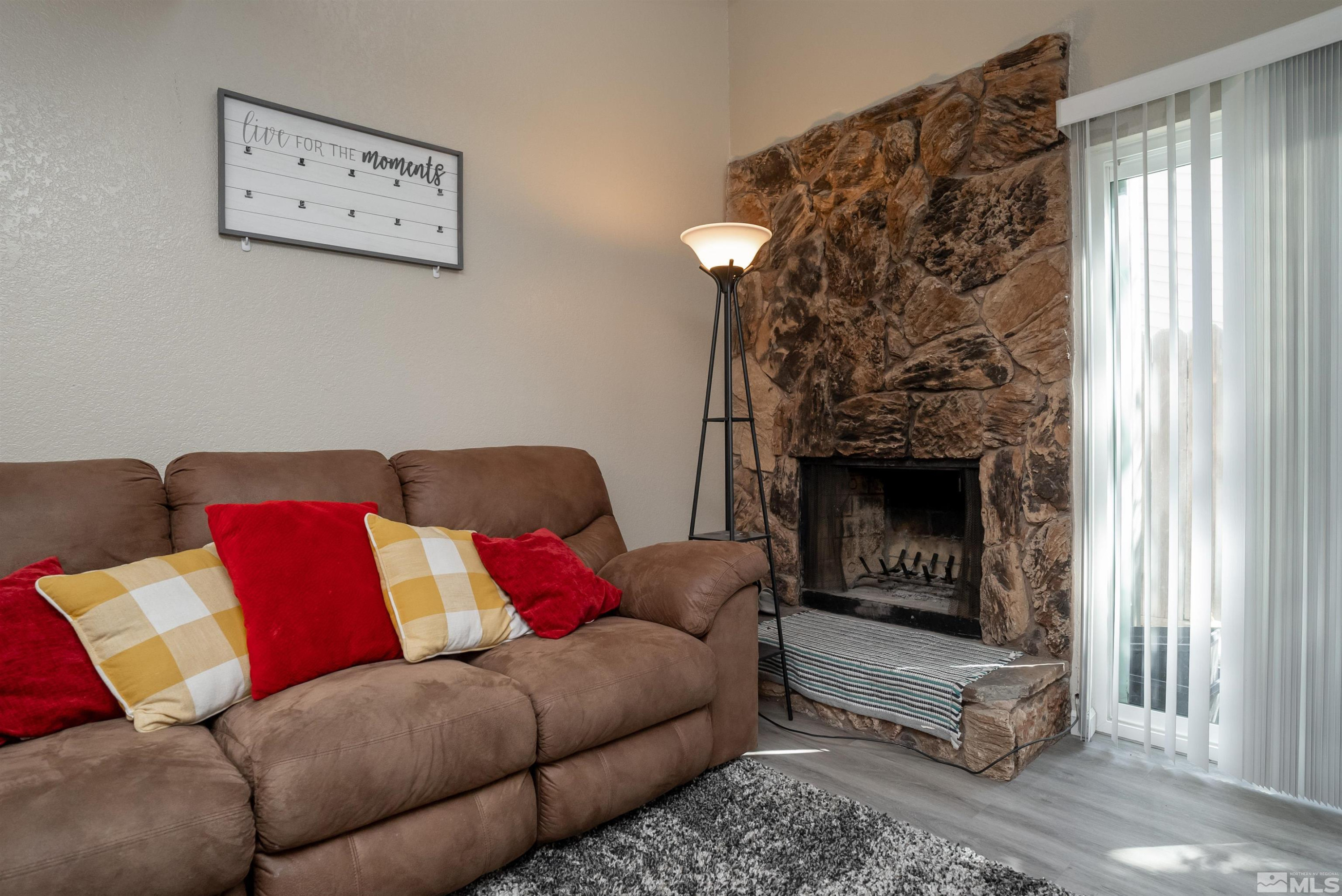 13864 Lear Boulevard Reno, NV 89506 - Photo 13 of 31 a living room with furniture a fireplace and a window