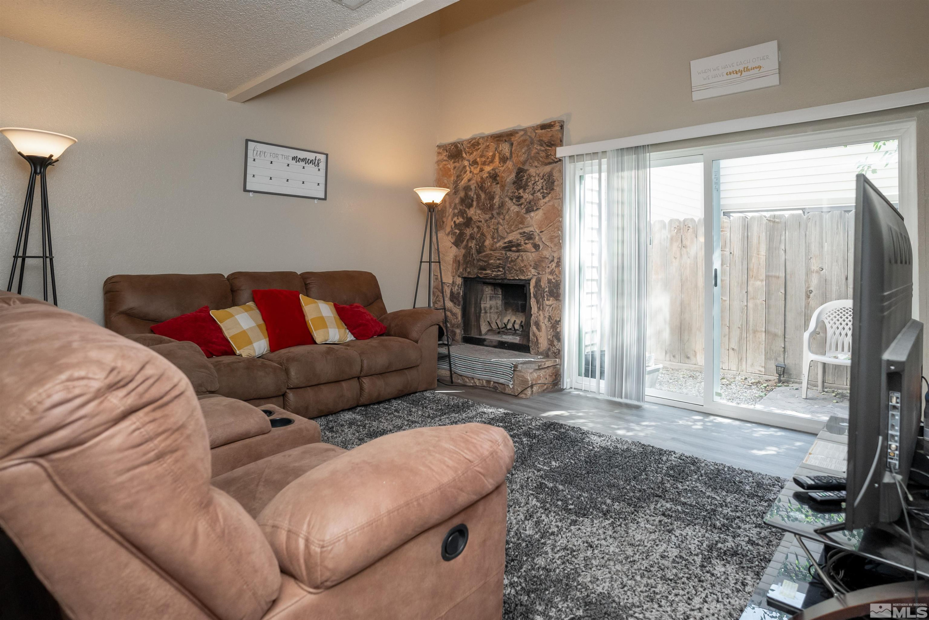 13864 Lear Boulevard Reno, NV 89506 - Photo 16 of 31 a living room with furniture and a fireplace