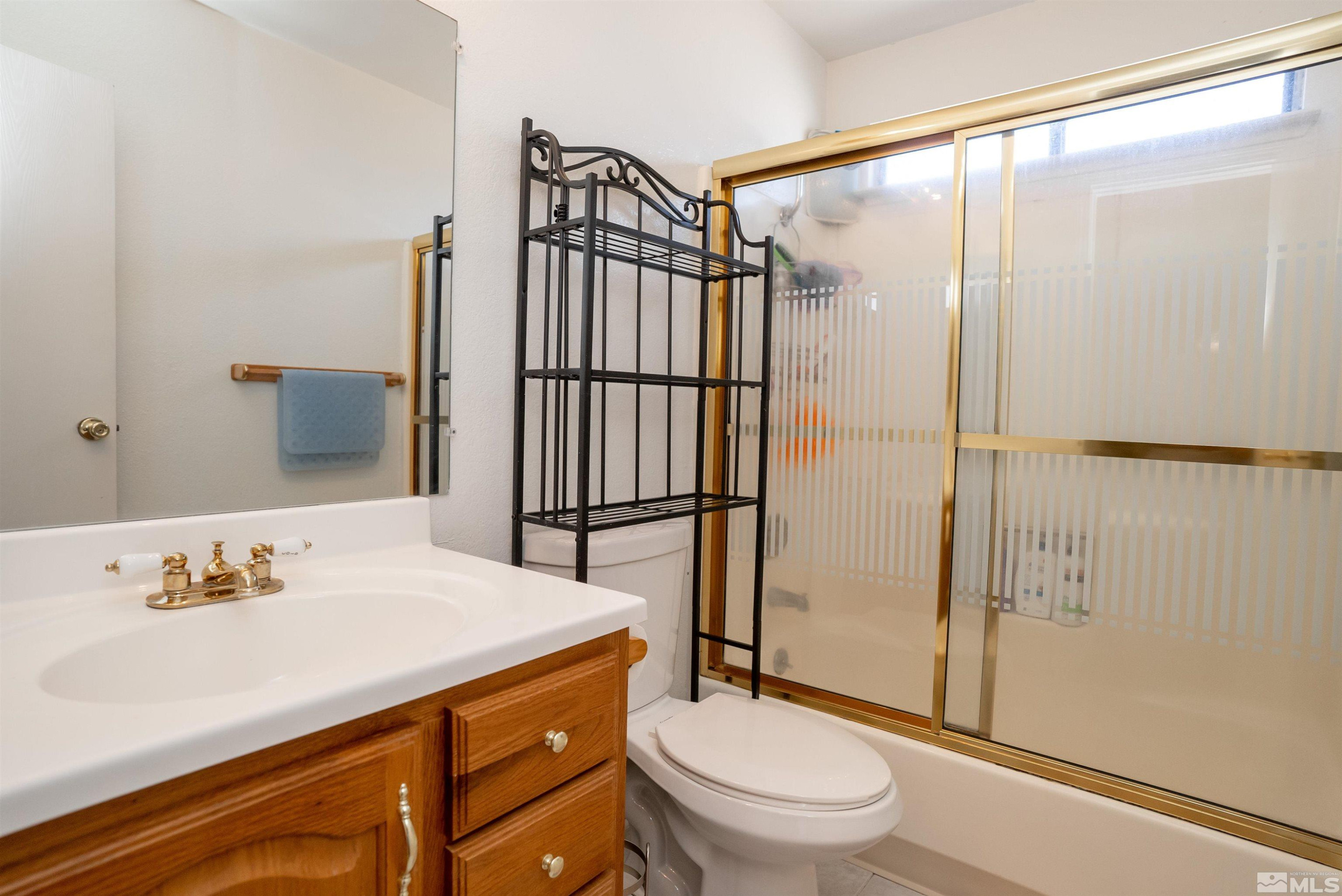 13864 Lear Boulevard Reno, NV 89506 - Photo 21 of 31 a bathroom with a sink toilet and shower
