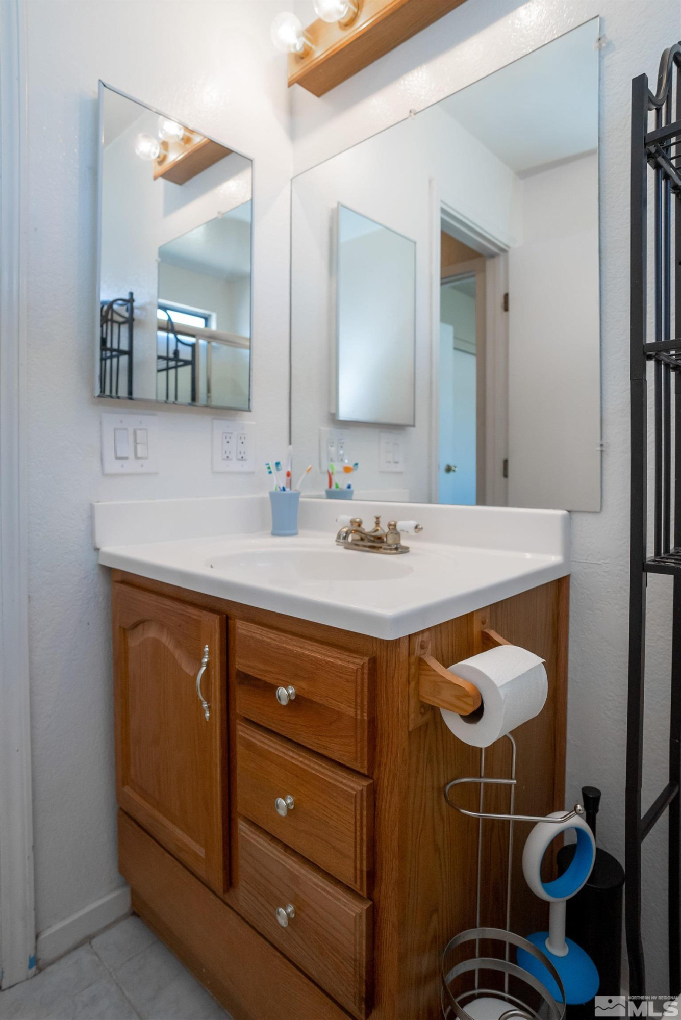 13864 Lear Boulevard Reno, NV 89506 - Photo 22 of 31 a bathroom with a sink vanity and mirror