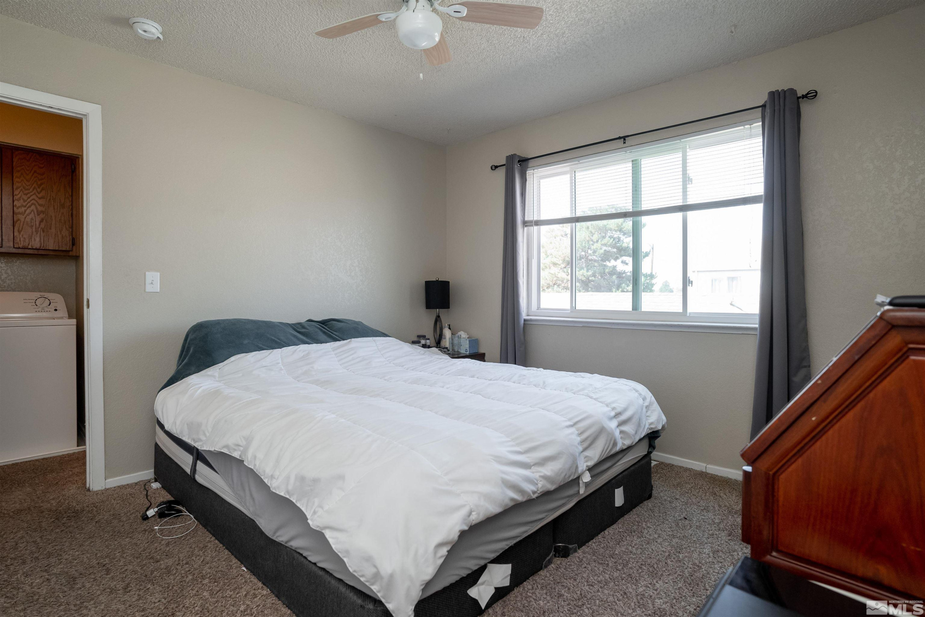 13864 Lear Boulevard Reno, NV 89506 - Photo 24 of 31 a bed sitting in a bedroom next to a window