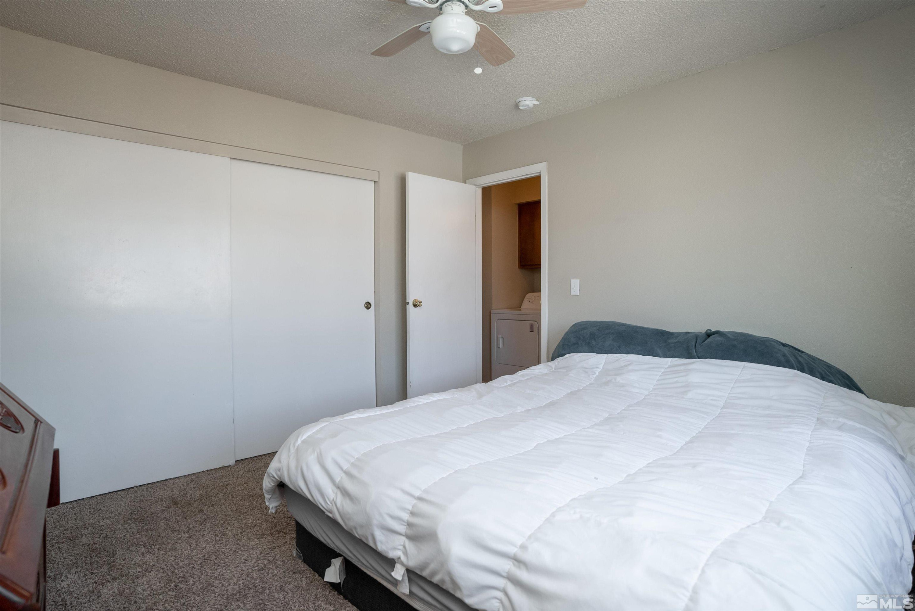 13864 Lear Boulevard Reno, NV 89506 - Photo 25 of 31 a bedroom with a bed and a chandelier