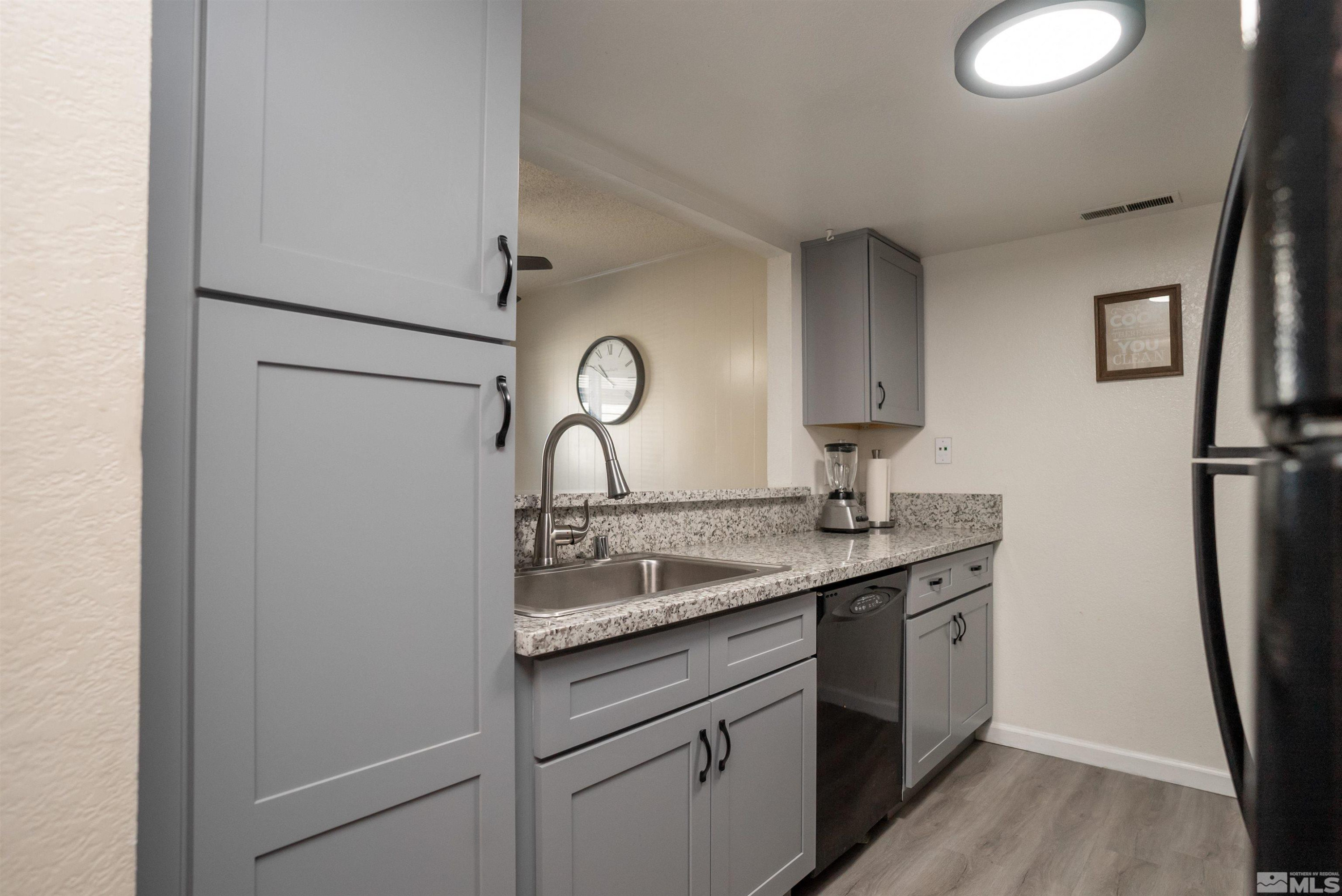 13864 Lear Boulevard Reno, NV 89506 - Photo 7 of 31 a kitchen with a sink and a refrigerator