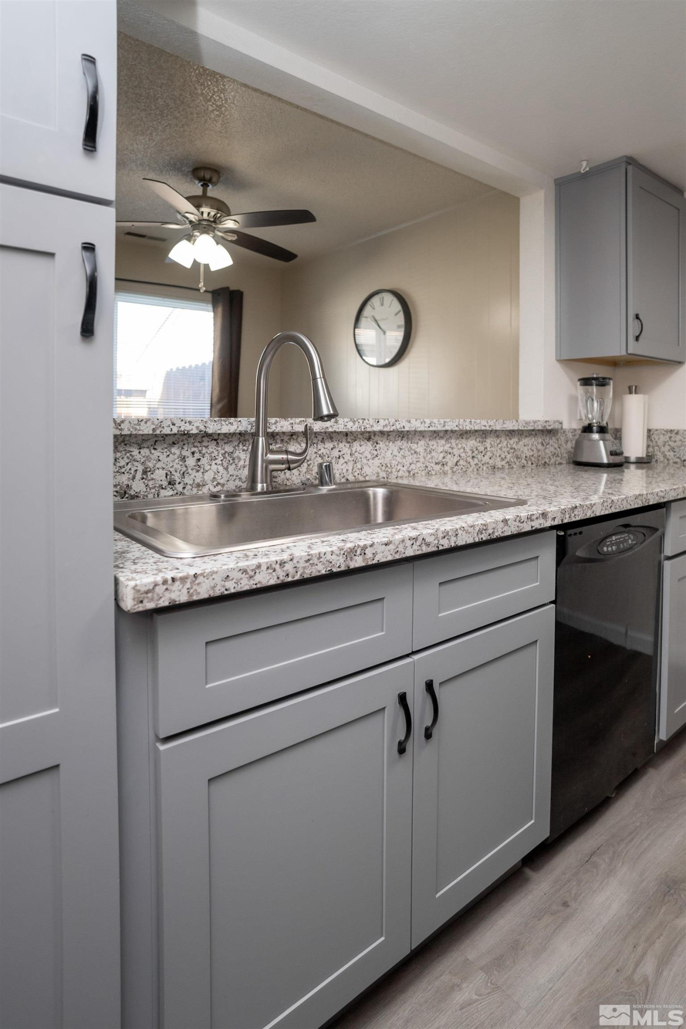 13864 Lear Boulevard Reno, NV 89506 - Photo 8 of 31 a bathroom with a granite countertop sink a vanity and dishwasher