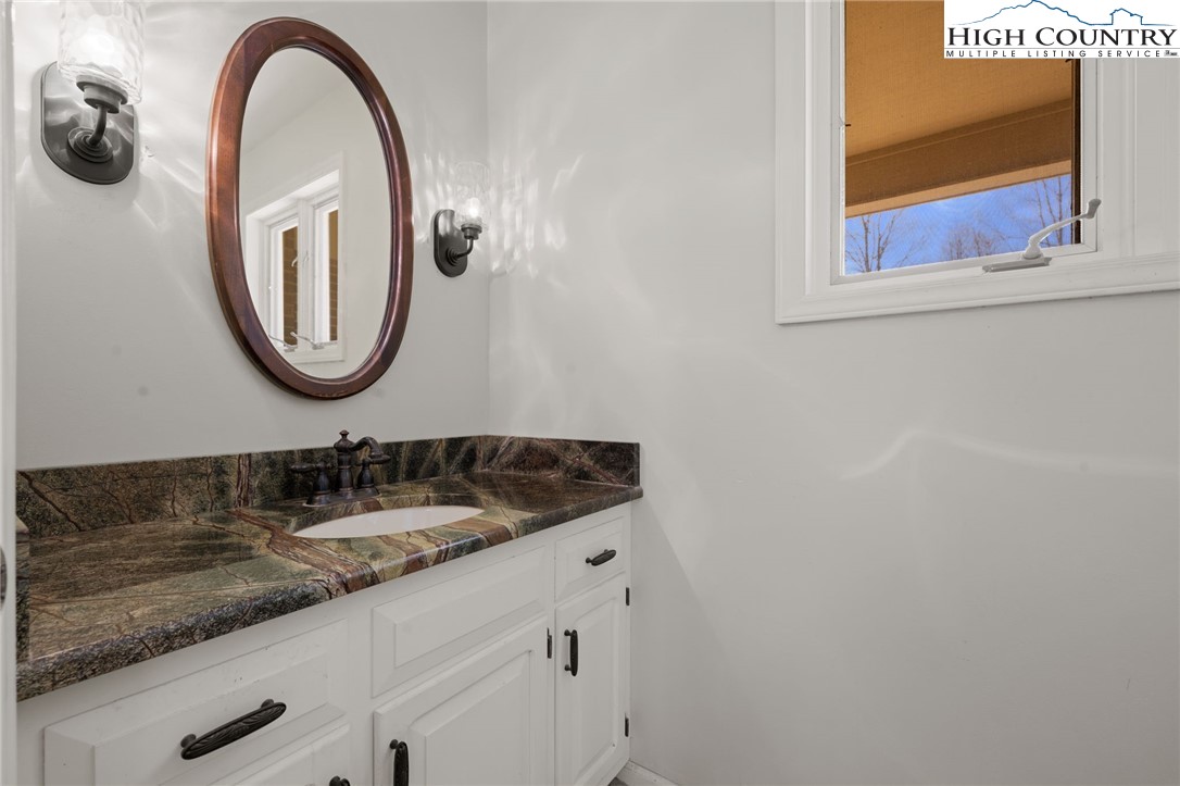 304 Glendale Drive Boone, NC 28607 - Photo 24 of 50 a bathroom with a granite countertop sink and a mirror