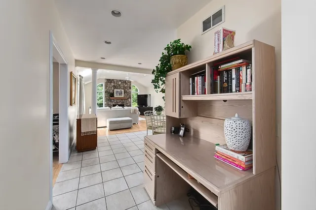 a living room with furniture and a book shelf