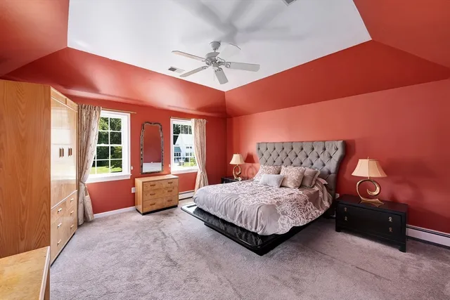 a spacious bedroom with a bed and a chandelier