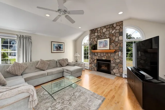 a living room with furniture a flat screen tv and a fireplace